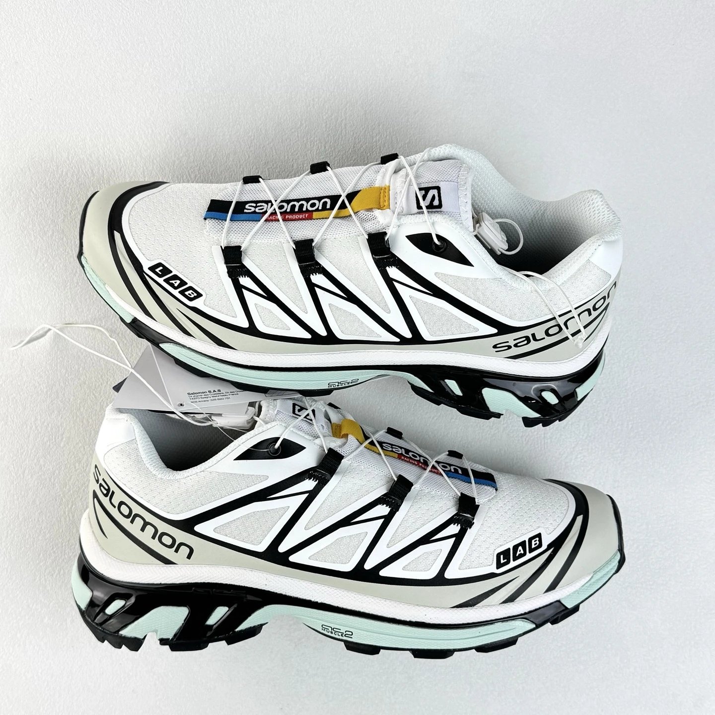 Salomon White and Black Trail Sneakers Highlighting Treaded Trail Sole