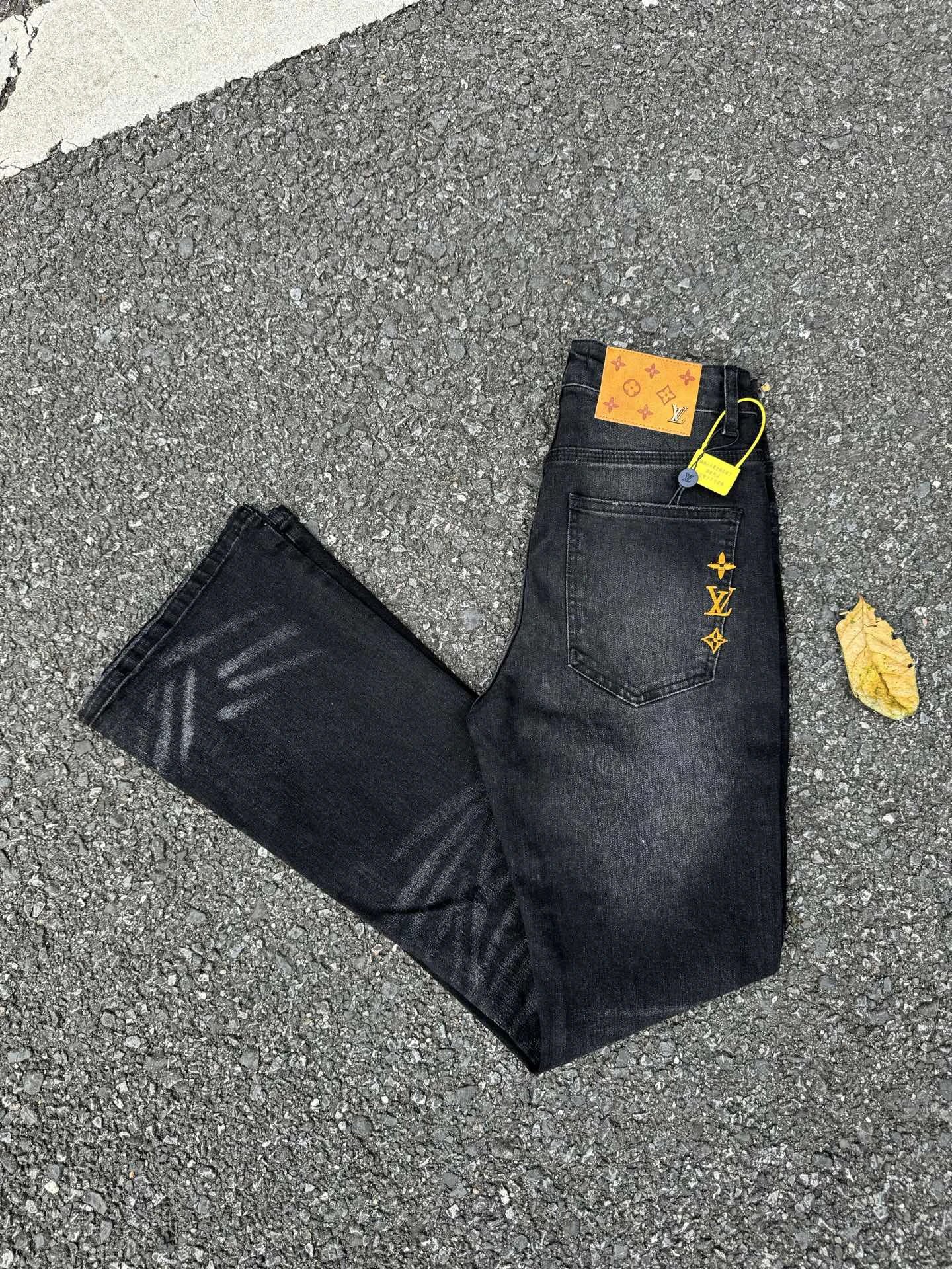 Graphic Jeans in Black with bold yellow marks and washed streetwear detailing - Evisu