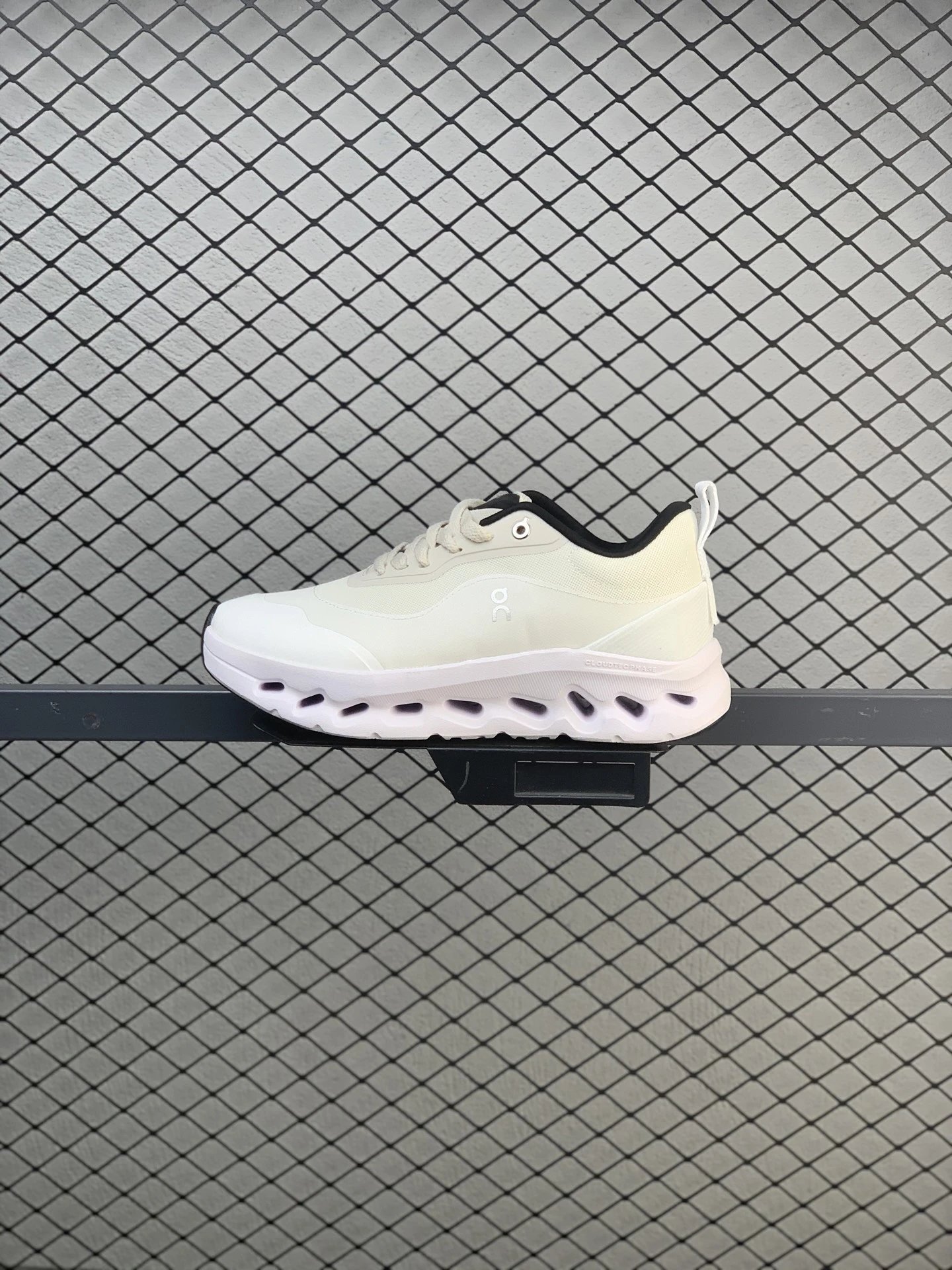 On Cloud Runners in White and Black, Finished with Layered Mesh Upper