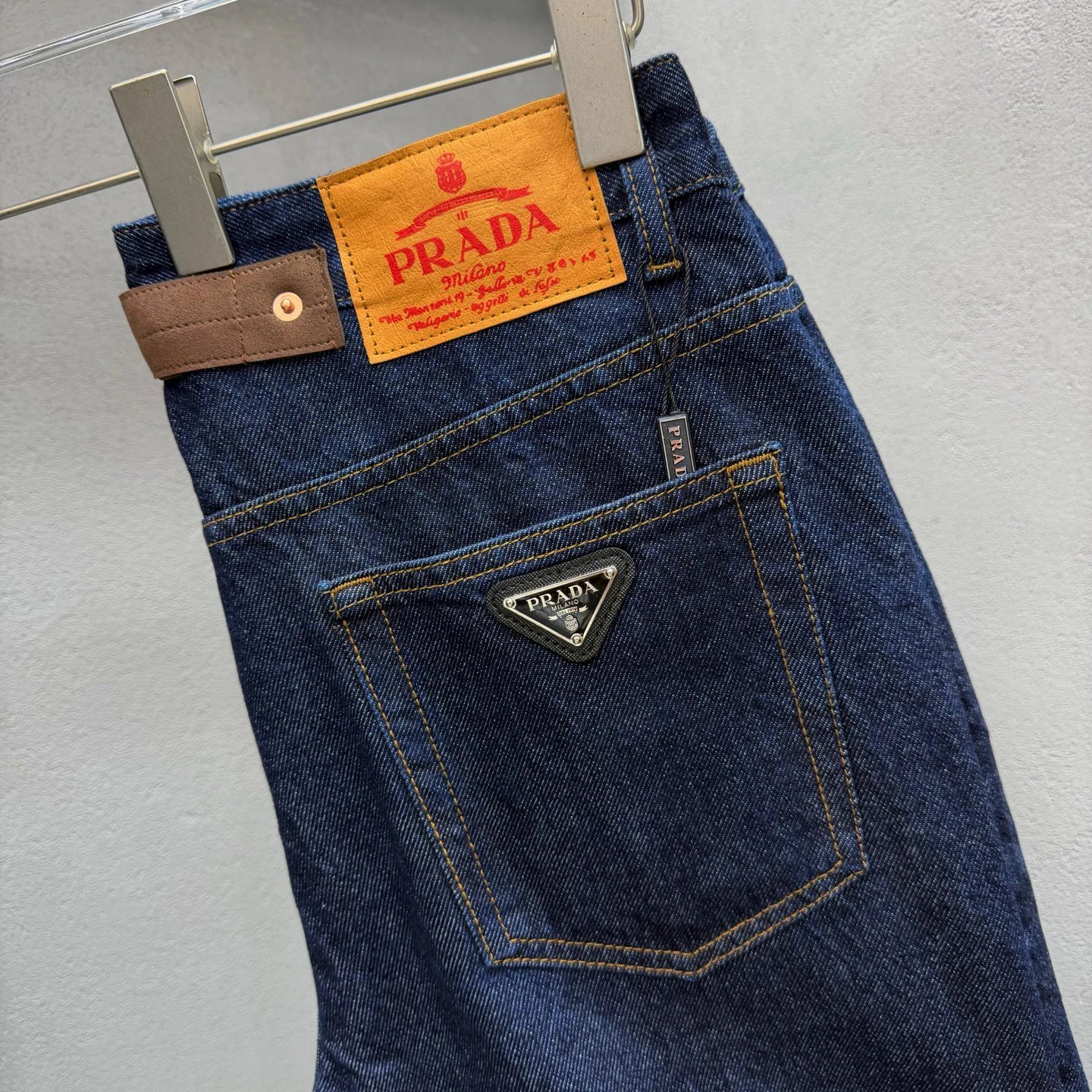 Streetwear Prada Logo Jeans with triangle branding and a statement leather back patch
