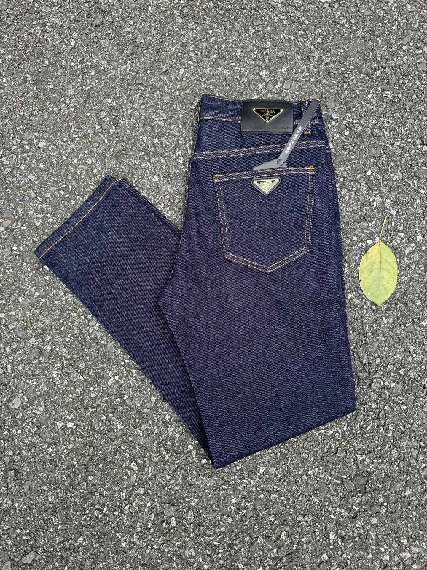 Prada Dark Indigo Logo Jeans with triangle badge hardware and contrast pocket stitching
