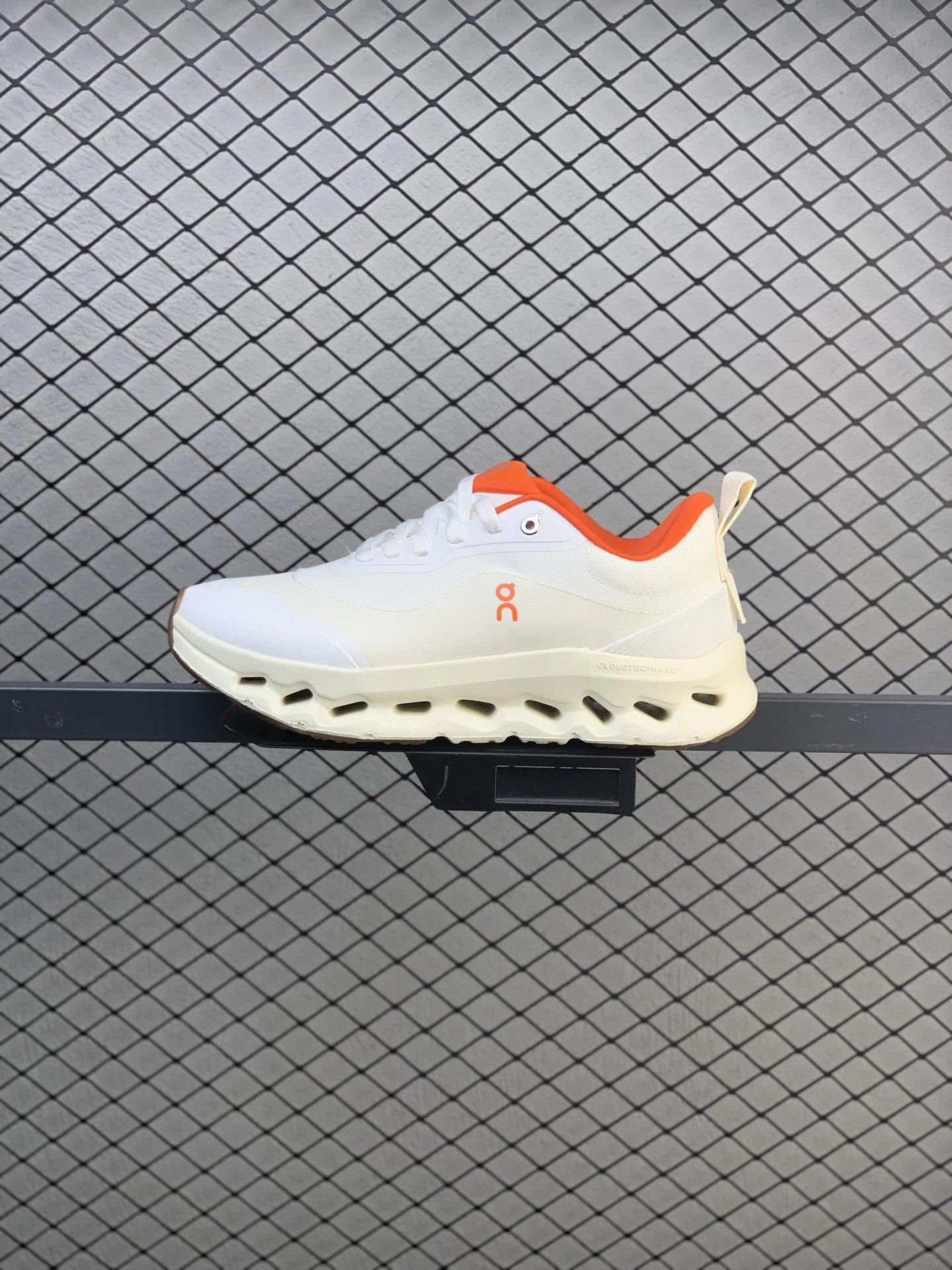 On Cloud Runners in White and Orange with Dynamic Sole Shape