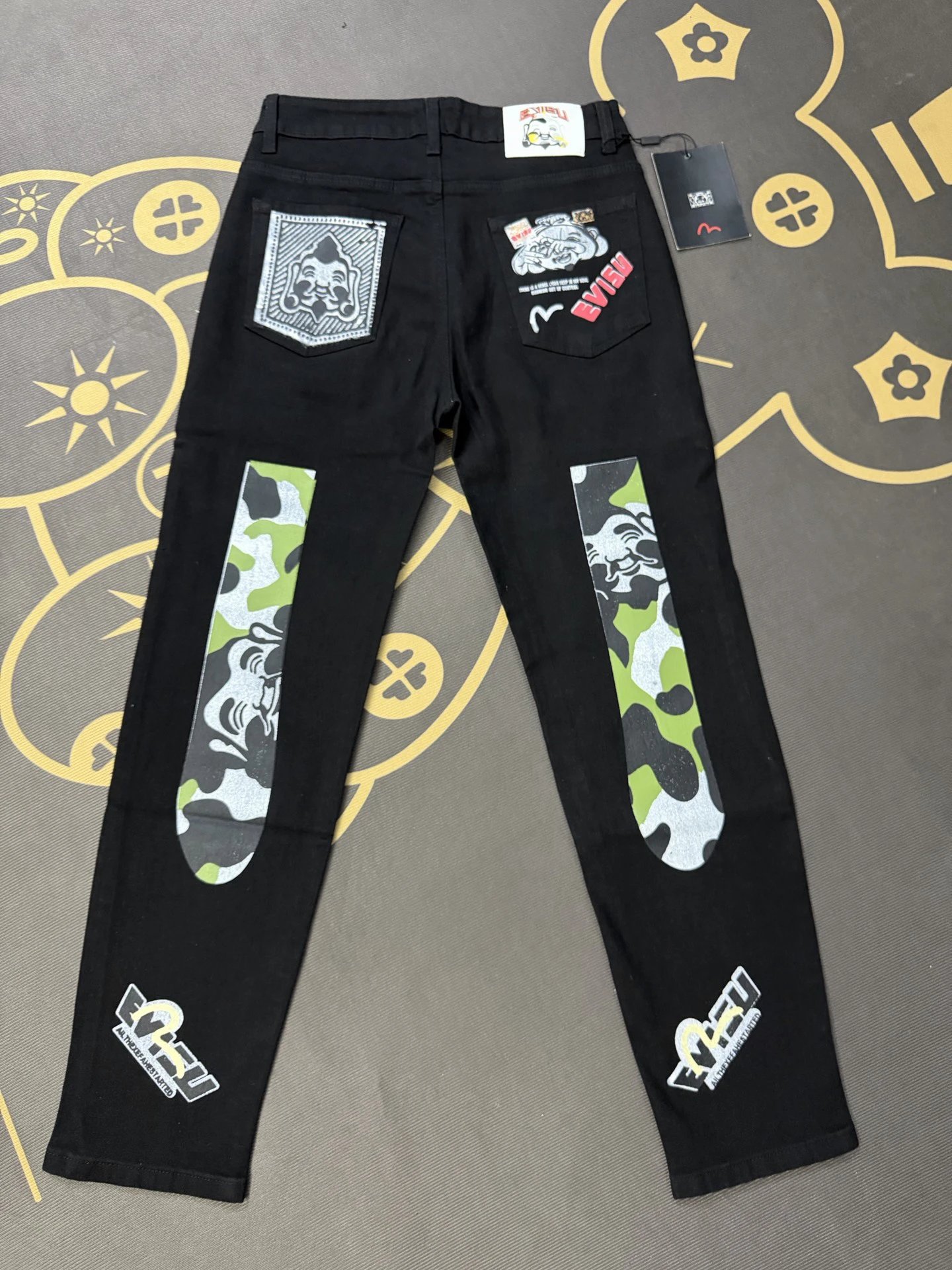 Evisu Weekend Patchwork Jeans with camouflage inserts and mixed graphic badges