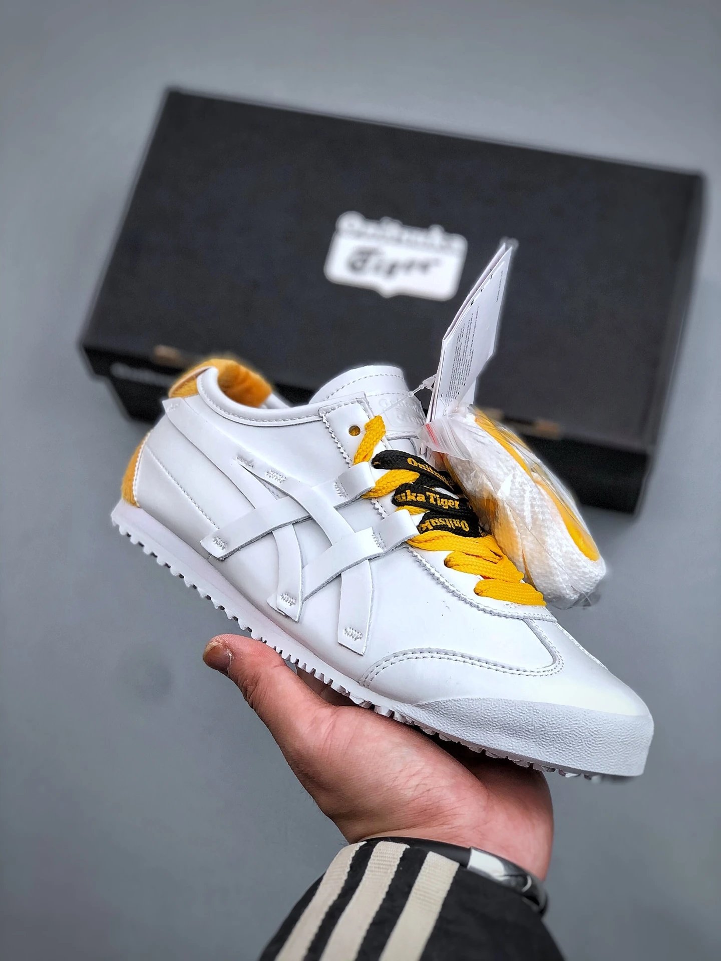 Onitsuka Tiger White and Yellow Low-Top Sneakers Highlighting Vintage-Inspired Shape