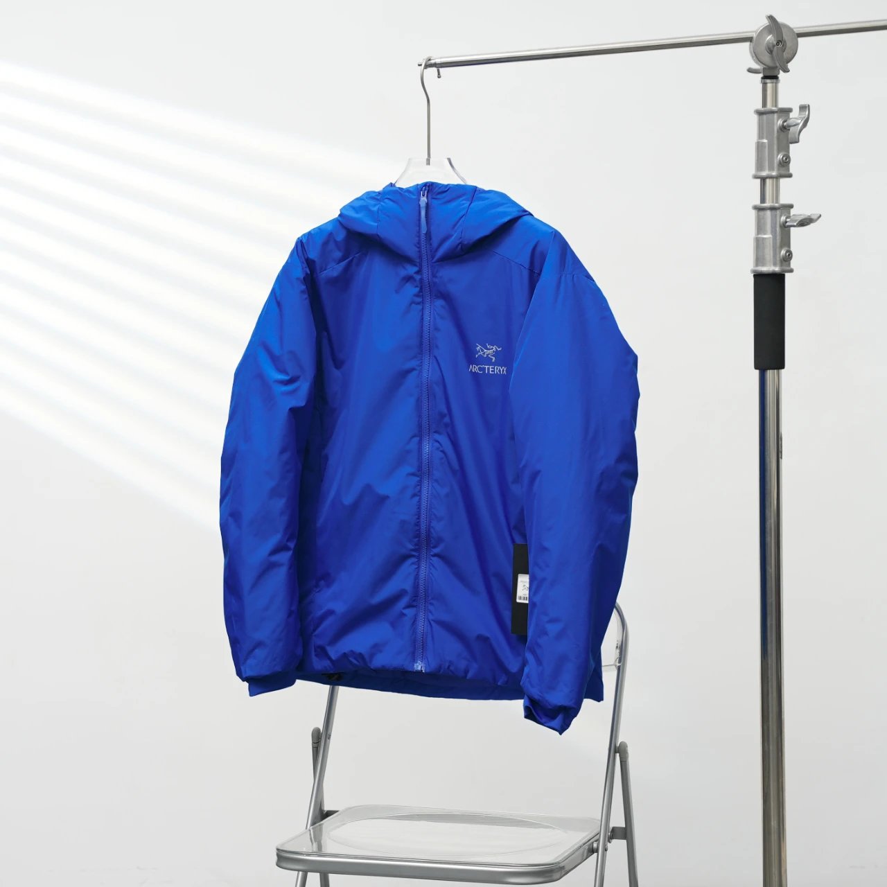Arc'teryx Royal Blue Lightweight Shell Jacket with vivid hooded finish and compact outdoor profile