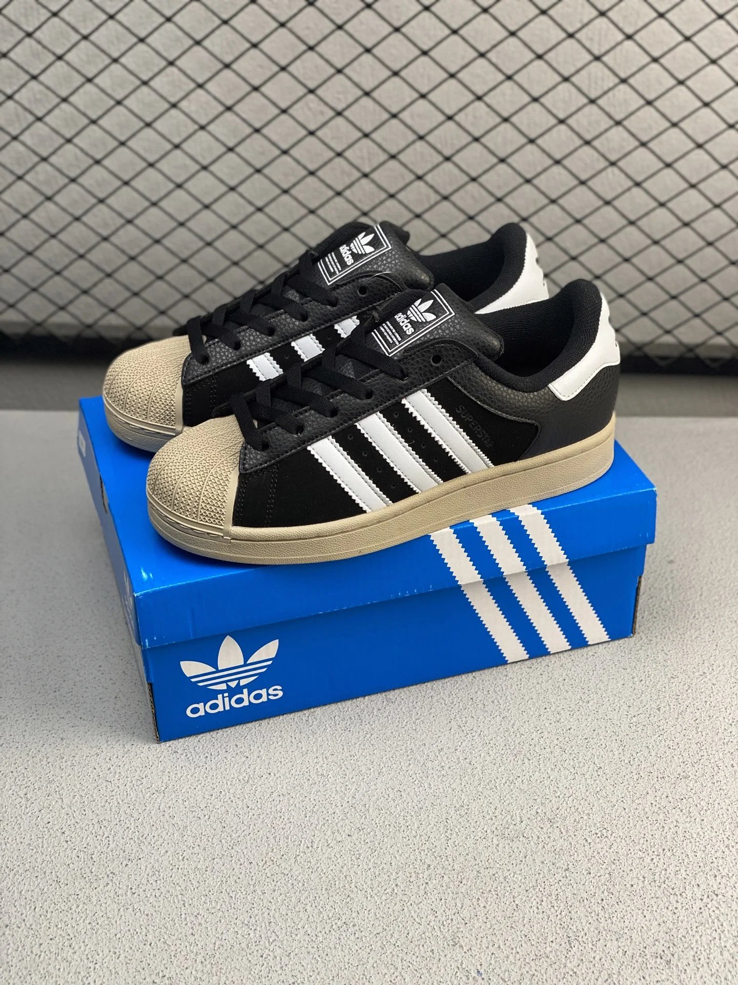 Adidas Black and Cream Shell-Toe Sneakers Highlighting Two-Tone Trim