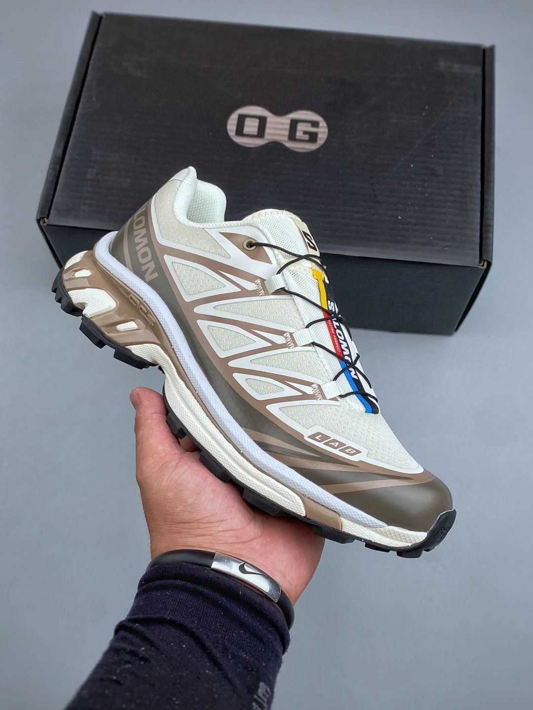 Salomon Tan and Gray Trail Runners Defined by Treaded Trail Sole