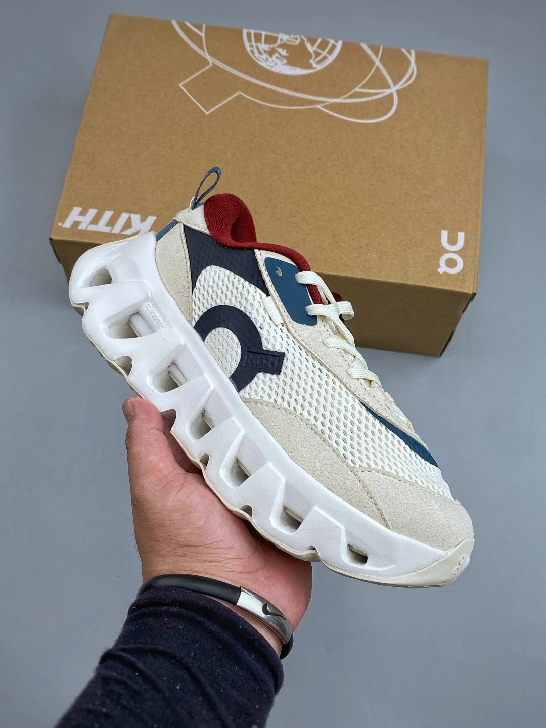 On Cloud Runners in Cream and Navy, Finished with Segmented Sole Pods