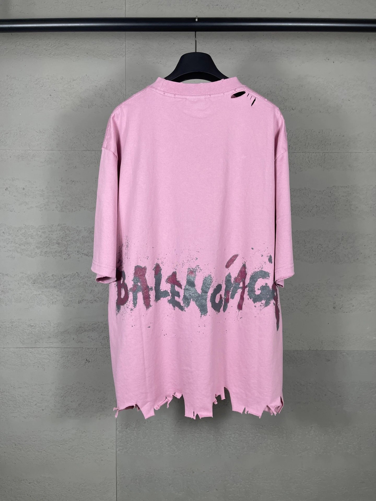 Balenciaga's pink T-shirt with a hole and graffiti style