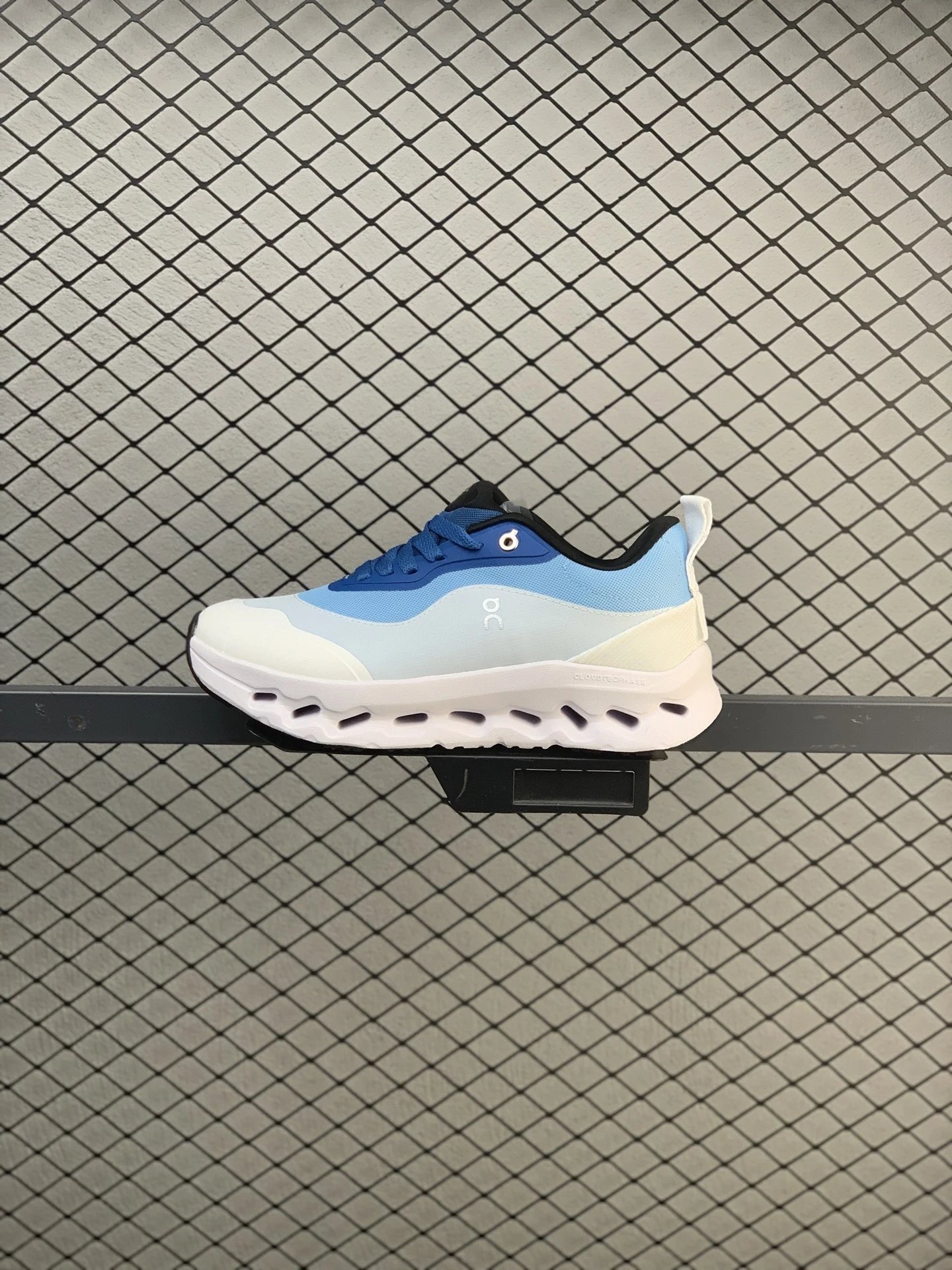 On White and Blue Cloud Runners Highlighting Open Mesh Panels